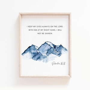 May include: A framed print with a watercolor painting of blue mountains and the text "I keep my eyes always on the Lord. With Him at my right hand, I will not be shaken. Psalm 16:8"