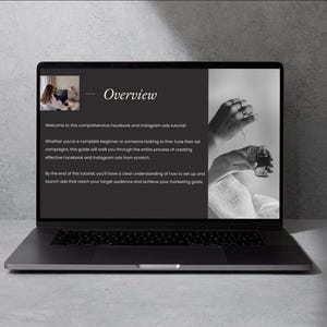 May include: A black laptop displays a presentation titled "Overview" with text about Facebook and Instagram ads tutorials. The screen shows a woman, hands with rings, and a small bottle. The laptop is on a gray surface.