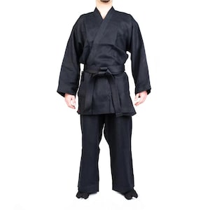 May include: A black martial arts uniform with a black belt. The uniform has a traditional style with a long, flowing top and trousers.