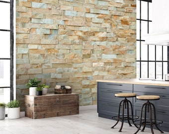 May include: A rustic wooden chest with metal accents sits in front of a wall covered in a faux stone tile pattern. The wall is a mix of beige, brown, and light green tones.