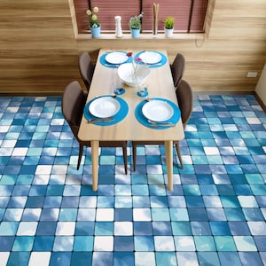 May include: A wooden dining table with four chairs, set with white plates and a blue and white tiled floor.
