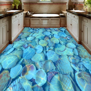 May include: A bathroom floor featuring a blue and white seashell design. The floor is made from a hard-wearing, waterproof material, ideal for adding a coastal touch to any bathroom.