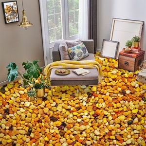 May include: A living room with a gray couch and a yellow blanket. The floor is covered in a thick layer of yellow and orange bee pollen.