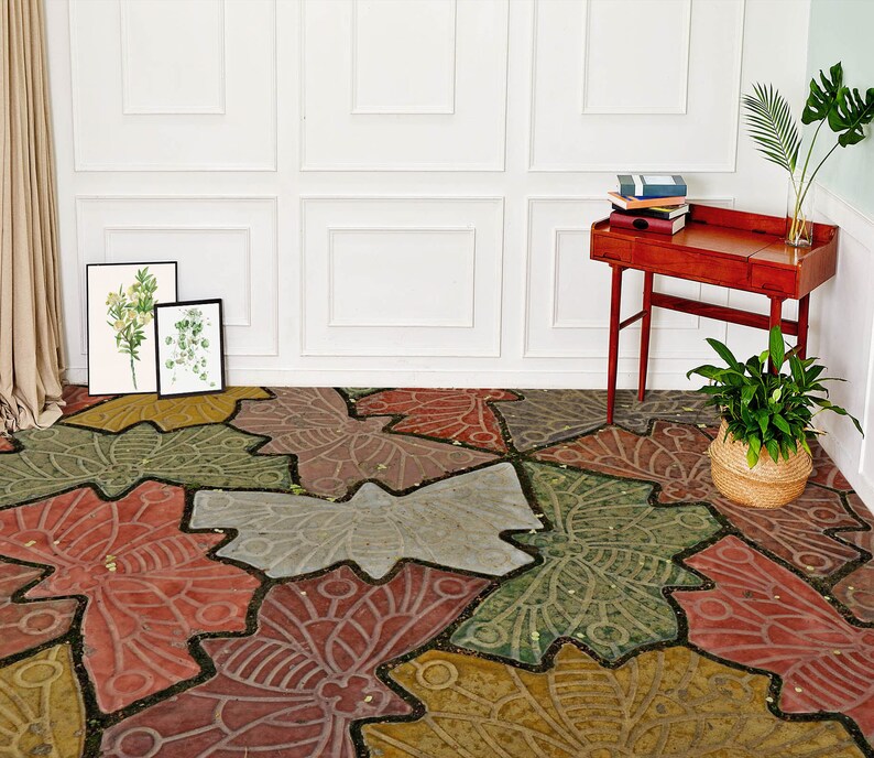 May include: A patterned floor with a design of overlapping butterfly wings in shades of red, green, brown, and gray. The floor is made of concrete or stone and has a rustic, vintage look.