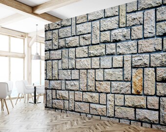 May include: A wall mural featuring a stone wall with a pattern of rectangular stones in various shades of grey and brown.