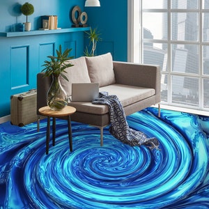 May include: A blue and turquoise swirl patterned floor rug in a living room with a gray couch, a side table, and a window with a city view.