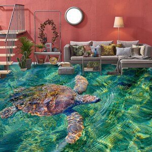 May include: A 3D floor covering with a realistic image of a sea turtle swimming in turquoise water. The turtle has a brown shell and is swimming towards the right side of the image.