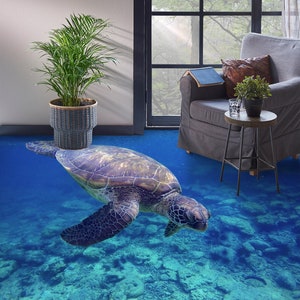 May include: A sea turtle swims through a blue and green underwater scene with rocks and coral. The turtle is in focus and the background is blurred. The scene is printed on a floor.