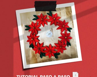 May include: A handmade poinsettia wreath with red petals and green leaves, arranged in a circular shape. The wreath is displayed on a wooden surface, attached to a white background with black tape. The text "TUTORIAL PASO A PASO" is visible.