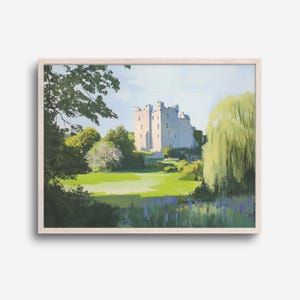 May include: A framed landscape painting depicts a castle on a sunny day. The castle is light-colored with a dark roof, set against a blue sky. Lush green grass and trees surround the castle, with a weeping willow on the right and purple flowers in the foreground.