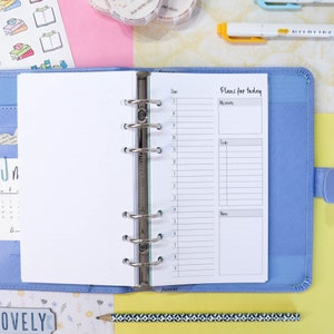 May include: A blue planner with a white page open to a daily planner spread. The page has a section for "Plans for today" with sections for "My priority", "To do", and "Notes".