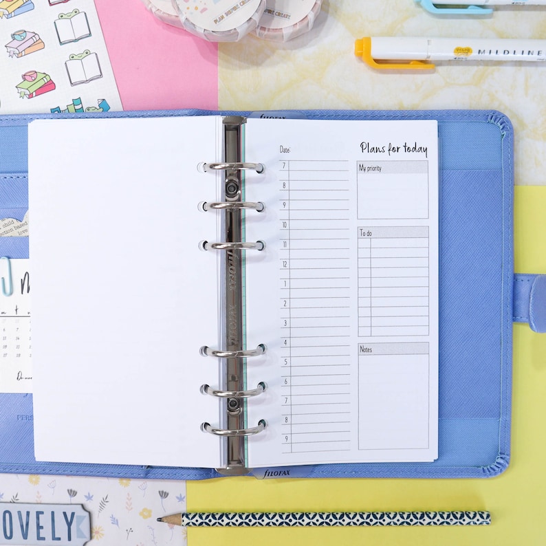 May include: A blue planner with a white page open to a daily planner spread. The page has a section for "Plans for today" with sections for "My priority", "To do", and "Notes".