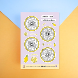 May include: A lilac sheet with lemon slice habit trackers. The design features four large lemon slice graphics with white segments and yellow outlines, plus smaller lemon illustrations and the text "Lemon slice habit trackers."