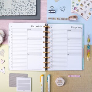 May include: A white planner with gold rings and a black and white patterned cover. The planner is open to a page with the words "Plans for today" written at the top. The page is divided into three sections: "My priority", "To do", and "Notes".