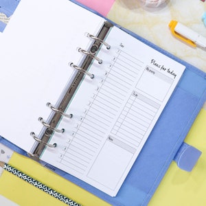 May include: A blue planner with a white page open to a daily planner section. The page has a section for "Date", "My priority", "To do", and "Notes". The page is labeled "Plans for today".