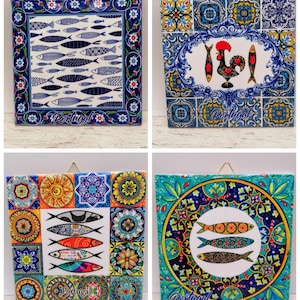 May include: Four square ceramic tiles with Portuguese designs. The tiles feature fish, rooster, and floral patterns in blue, orange, yellow, and green. Each tile has a gold wire for hanging. The word "Portugal" is written on some tiles.