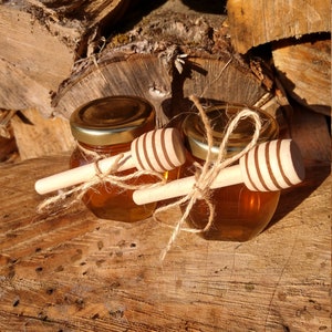 Raw unfiltered wildflower honey from Vermont in a 3 oz. glass jar with honey dipper