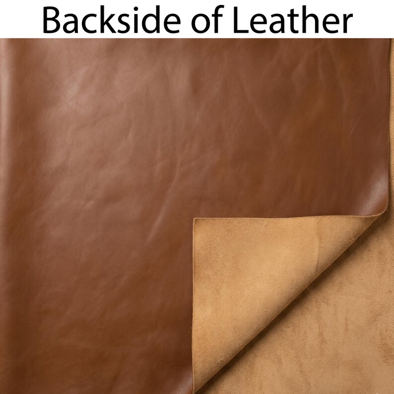 May include: A close-up of brown leather with the text "Backside of Leather" at the top. The leather is folded over to reveal a lighter tan underside. The leather has a smooth, slightly shiny surface.