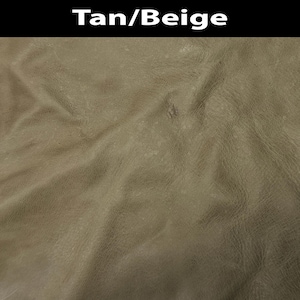 K&ouml;nnte beinhalten: Ein strukturiertes Material in Beige und Hellbraun mit nat&uuml;rlicher Maserung und sichtbaren Falten. Die Oberfl&auml;che hat ein mattes Finish mit subtilen Farbnuancen. Der Text Tan/Beige ist in Wei&szlig; auf einem schwarzen Balken oben abgebildet.