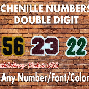 May include: Three chenille numbers, 56, 23, and 22, are displayed on a brick wall. The numbers are in different colors: black and yellow, maroon and white, and green and white. The text "CHENILLE NUMBERS DOUBLE DIGIT" is at the top of the image. The text "Quick Delivery - Made in USA" is below the numbers. The text "Any Number/Font/Color" is at the bottom of the image.