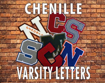 May include: A collection of multi-coloured chenille varsity letters featuring various fonts and borders, layered together. The letters include shades of red, blue, grey, white, and green, with some displaying text like ESPORTS and MESA. The words CHENILLE VARSITY LETTERS are printed in white at the top and bottom.