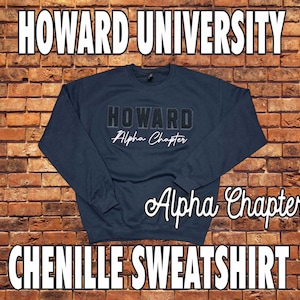 May include: Navy blue chenille sweatshirt with "HOWARD UNIVERSITY" and "Alpha Chapter" text. The sweatshirt has a crew neck and long sleeves. The text is in white and black.