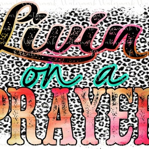 May include: A graphic design with the words "Livin' on a Prayer" in a distressed, colorful font. The background features a leopard print pattern in black, white, and tan.