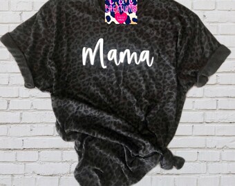 May include: Black t-shirt with a leopard print and the word "Mama" in white text.