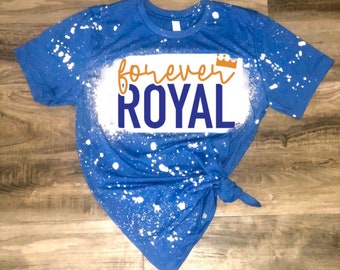 May include: A blue t-shirt with white splatter paint and the text "forever ROYAL" in orange and blue with a gold crown.