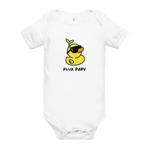 May include: White baby bodysuit featuring a cartoon yellow duck wearing sunglasses and a green sprout. The text "PLUR BABY" is printed below the duck. The bodysuit has short sleeves and snap closures.