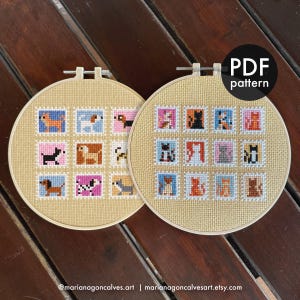 May include: Two embroidery hoops with cross-stitch designs. One features dogs, the other cats, each in a postage stamp style. The hoops are beige, and the designs use various colors. The text "PDF pattern" is visible on one hoop.