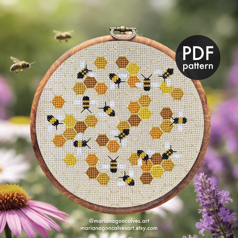 Peut inclure: Un cercle de broderie au point de croix avec un motif d'abeille et de nid d'abeille. Le motif comprend des hexagones jaunes, bruns et blancs avec des abeilles noires et jaunes. Le texte "PDF pattern" est en haut &agrave; droite. Le nom et le site web de l'artiste sont en bas.