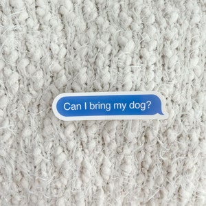 “Can I bring my dog?” sticker on chunky white knit blanket.
