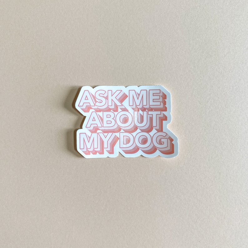 waterproof light pink sticker that reads ask me about my dog against cream background