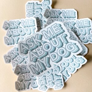 multiple light blue stickers scattered that read ask me about my dog