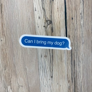 Sticker on rustic wood background with visible grain texture.