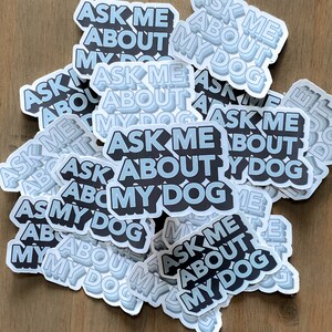 navy blue and light blue stickers scattered that read ask me about my dog