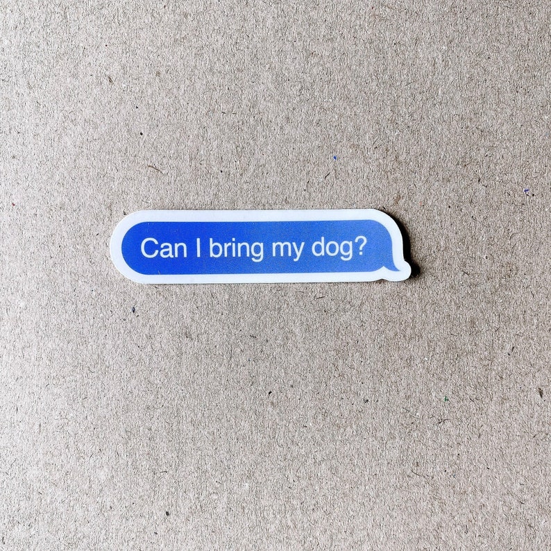 Close-up of “Can I bring my dog?” sticker on textured cardboard background.