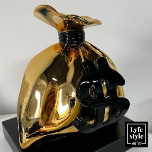 Statua pop art Gold Money Bag (scultura) ispirata al monopolio di Alec, cromata