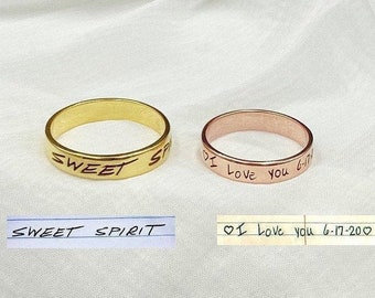 May include: Two gold rings with engraved messages. The first ring is gold and says "SWEET SPIRIT". The second ring is rose gold and says "I love you 6-17-20".