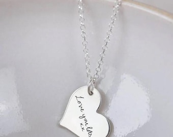 May include: A silver necklace with a heart-shaped pendant that says "Love you lots xx".