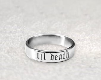 May include: A silver band ring with the words "til death" engraved in a gothic font.
