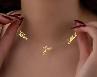 May include: A gold necklace with three names, "Tiffini", "Jose", and "Ilah", written in cursive script.