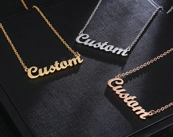 May include: Three gold, silver, and rose gold necklaces with the word "Custom" written in a cursive font.