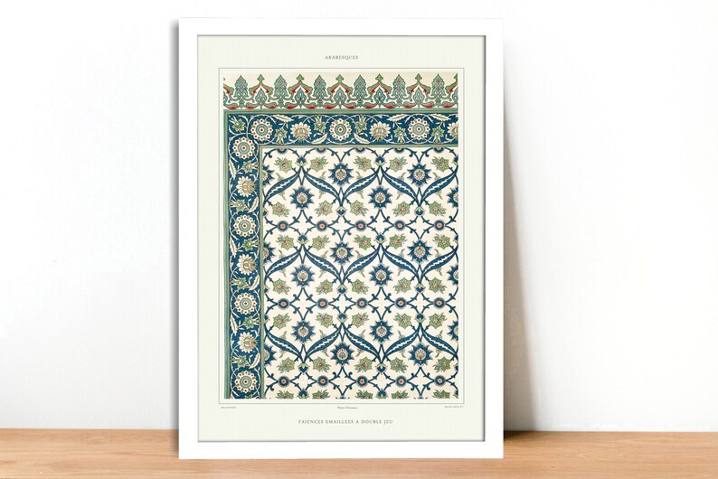 May include: Framed print featuring a detailed, vintage arabesque design. The artwork showcases a repeating floral pattern in shades of blue, green, and cream, with intricate border details. The print is set in a white frame, adding a classic touch.