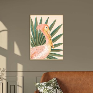 May include: A pink pelican with a long beak is depicted in a tropical setting with green palm leaves. The pelican is facing to the right and the leaves are behind it. The background is a light peach color.