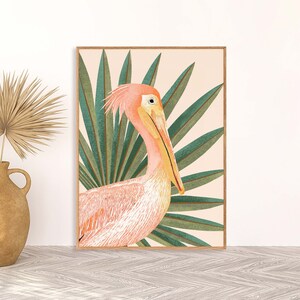 May include: A pink and white pelican with a long beak is depicted in a digital illustration. The pelican is surrounded by green palm leaves against a light pink background.