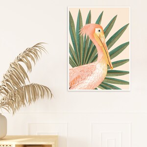 May include: A pink pelican with a long yellow beak is depicted in a watercolor style against a background of green palm leaves. The pelican is facing the right side of the image.