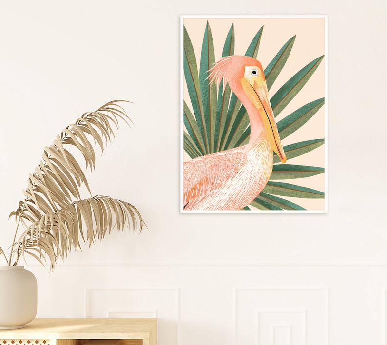 May include: A pink pelican with a long yellow beak is depicted in a watercolor style against a background of green palm leaves. The pelican is facing the right side of the image.