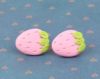 May include: A pair of pink and green strawberry-shaped earrings.